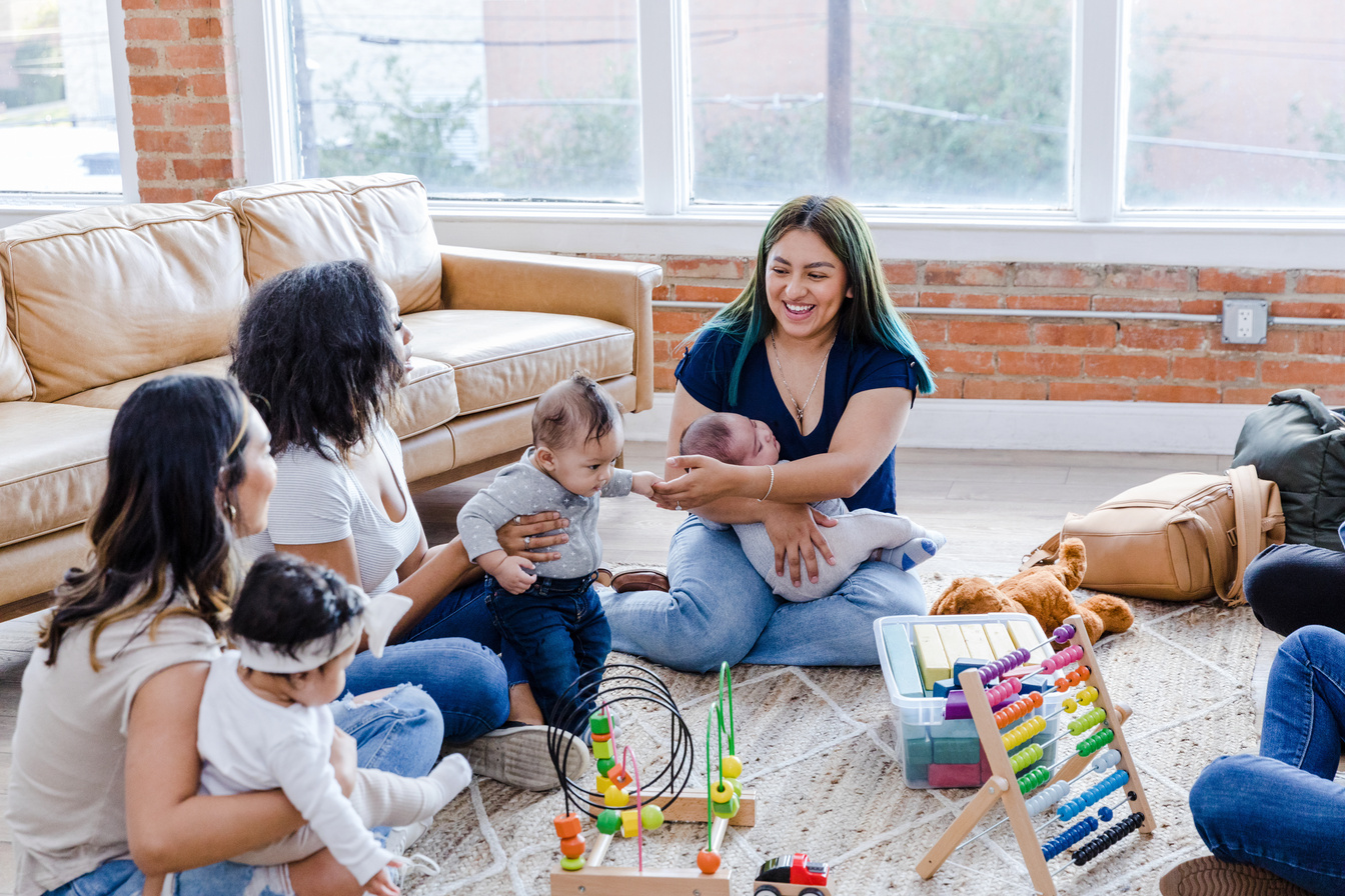 Multiracial group of moms and babies meet to play