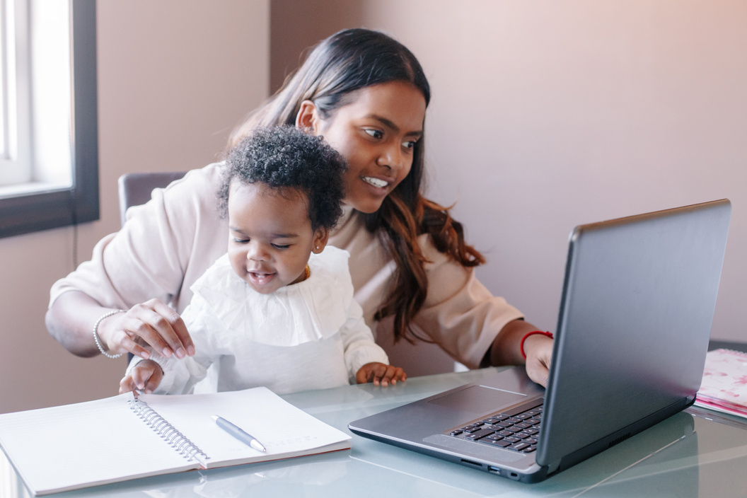 Diverse Family: Mother with Baby Working Online